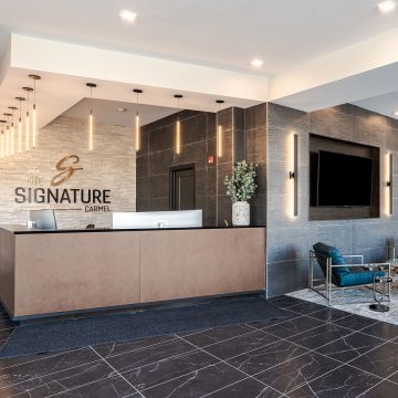 The Signature at Carmel Lobby with beautiful metallic and stone finishes.