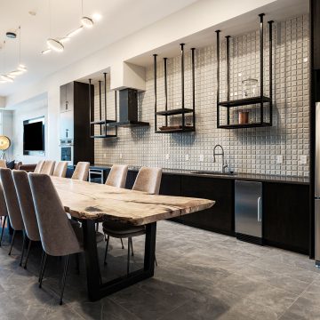 Live edge conference table for twelve high backed chairs with a wet sink and counter.