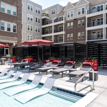 Gorgeous pool with cabanas, chaise lounges and partially submerged sun loungers.